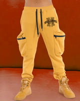Model wearing hollywood printed yellow cargo pant with yellow sneakers
