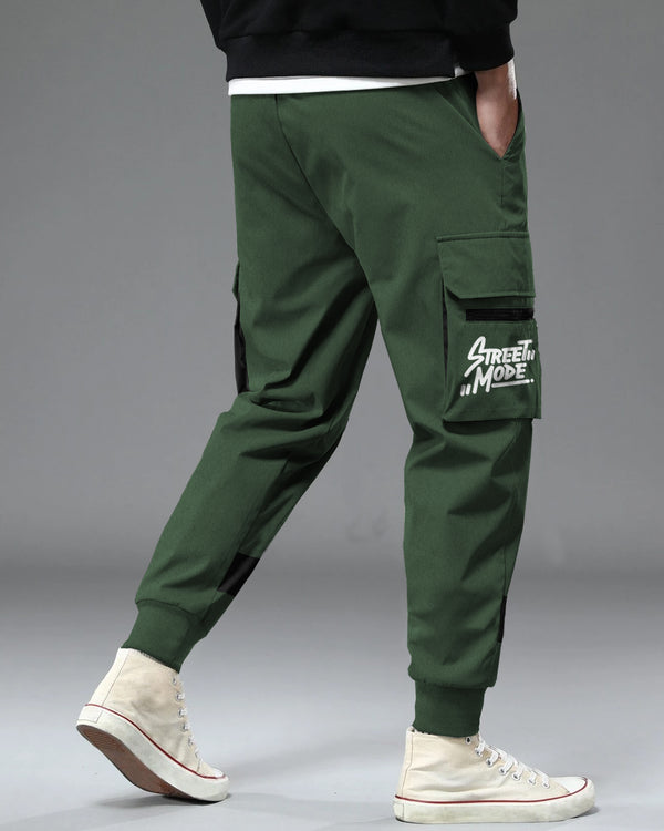 Model wearing olive green color cargo pant with white sneakers back view