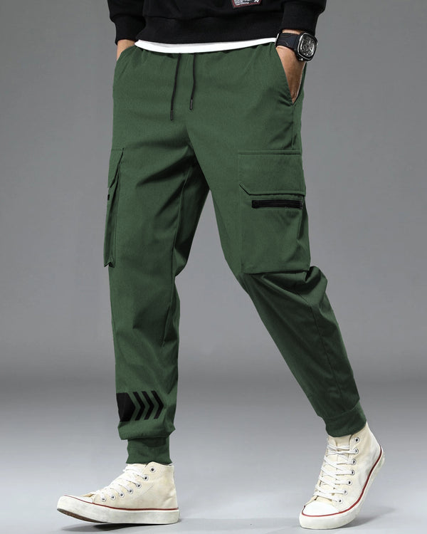 Model wearing olive green color cargo pant with white sneakers front view