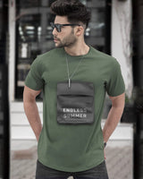 model wearing olive green t shirt and also wears neck chain and black coolers