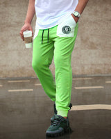 Model wearing newyork word printed apple green skinny cargo pant with sneakers and having beverages