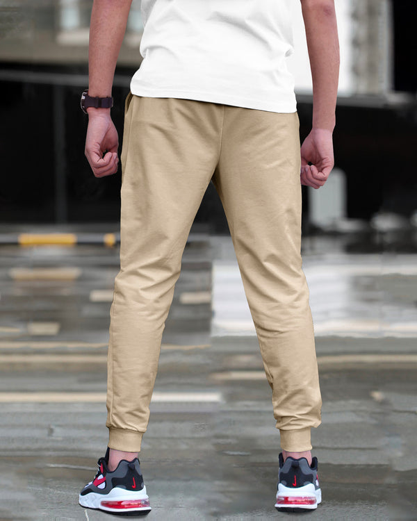 Model wearing printed beige cargo pant with sneakers