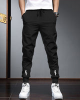 Men Solid Black Elastic Cuffed Ankles Drawstring TrackPant