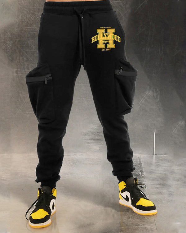 Model wearing HOLLYWOOD word printed black cargo pant with sneakers