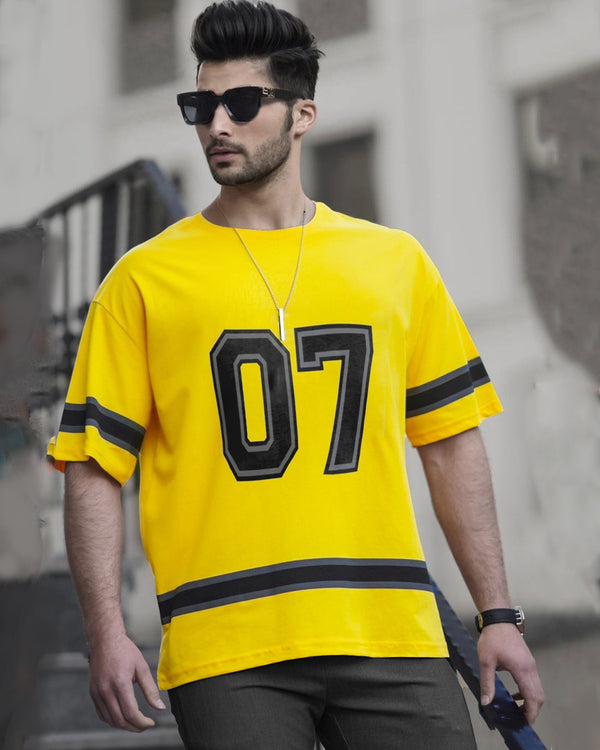 Model wearing Yellow sports oversized 07 t shirt for men with black coolers